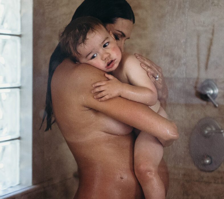 Sweet photo of pregnant mom with toddler in shower